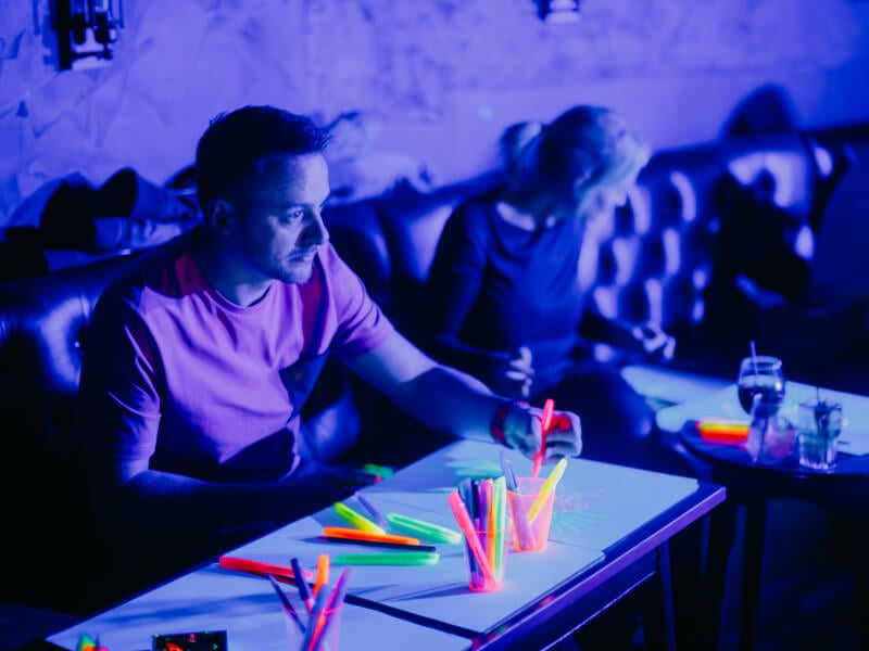 A group of people at a neon life drawing class