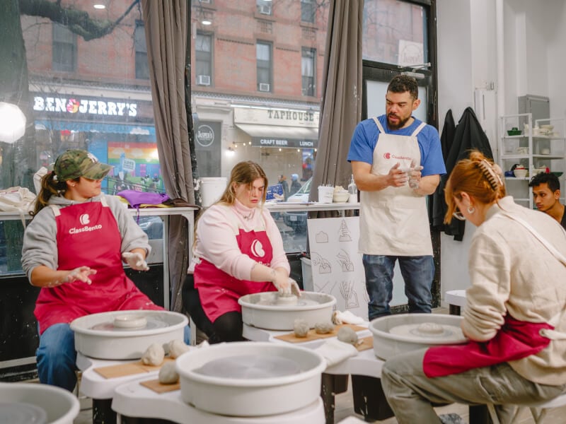 A group of people having fun at a pottery class