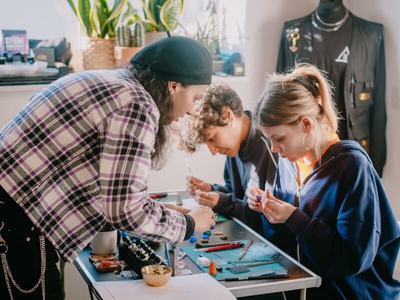 A couple being taught at a jewellery making class
