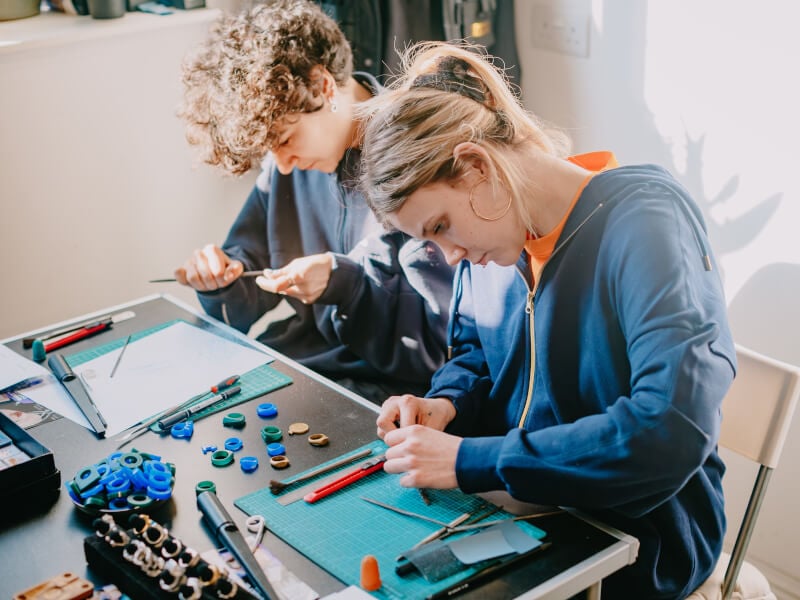 Two people at a jewellery making class