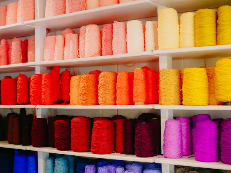 A wall full of yarn cones in every colour imaginable 