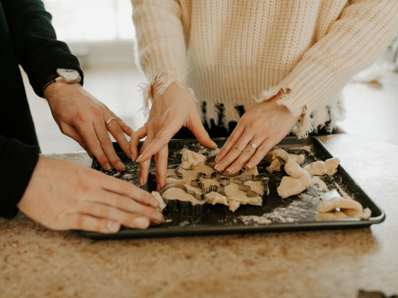 Two people work together on a fun group activity of baking.