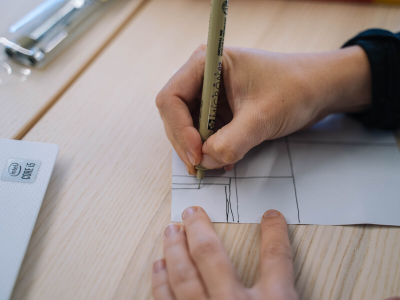 Close up of hands making a geometric drawing on paper