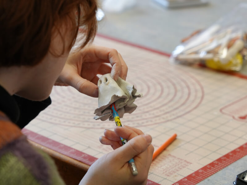 A person making an air dry clay ghost