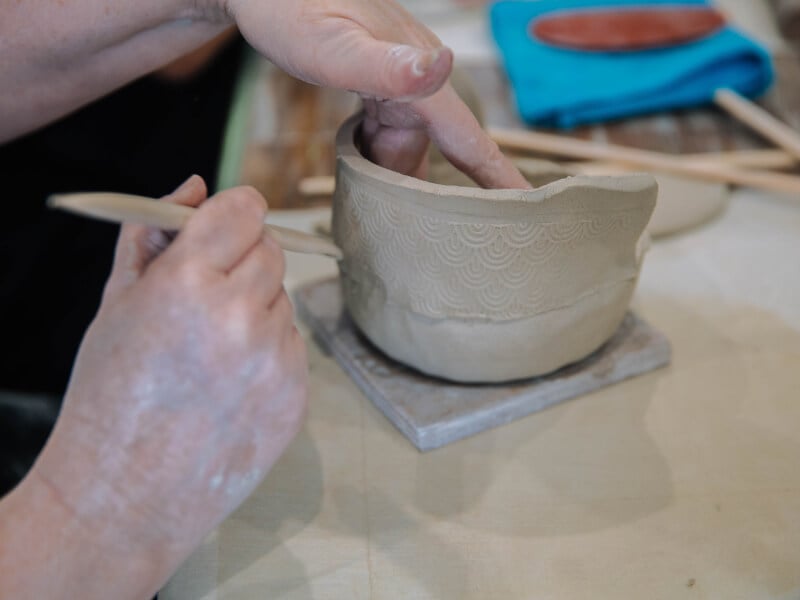 Hand building clay pot.