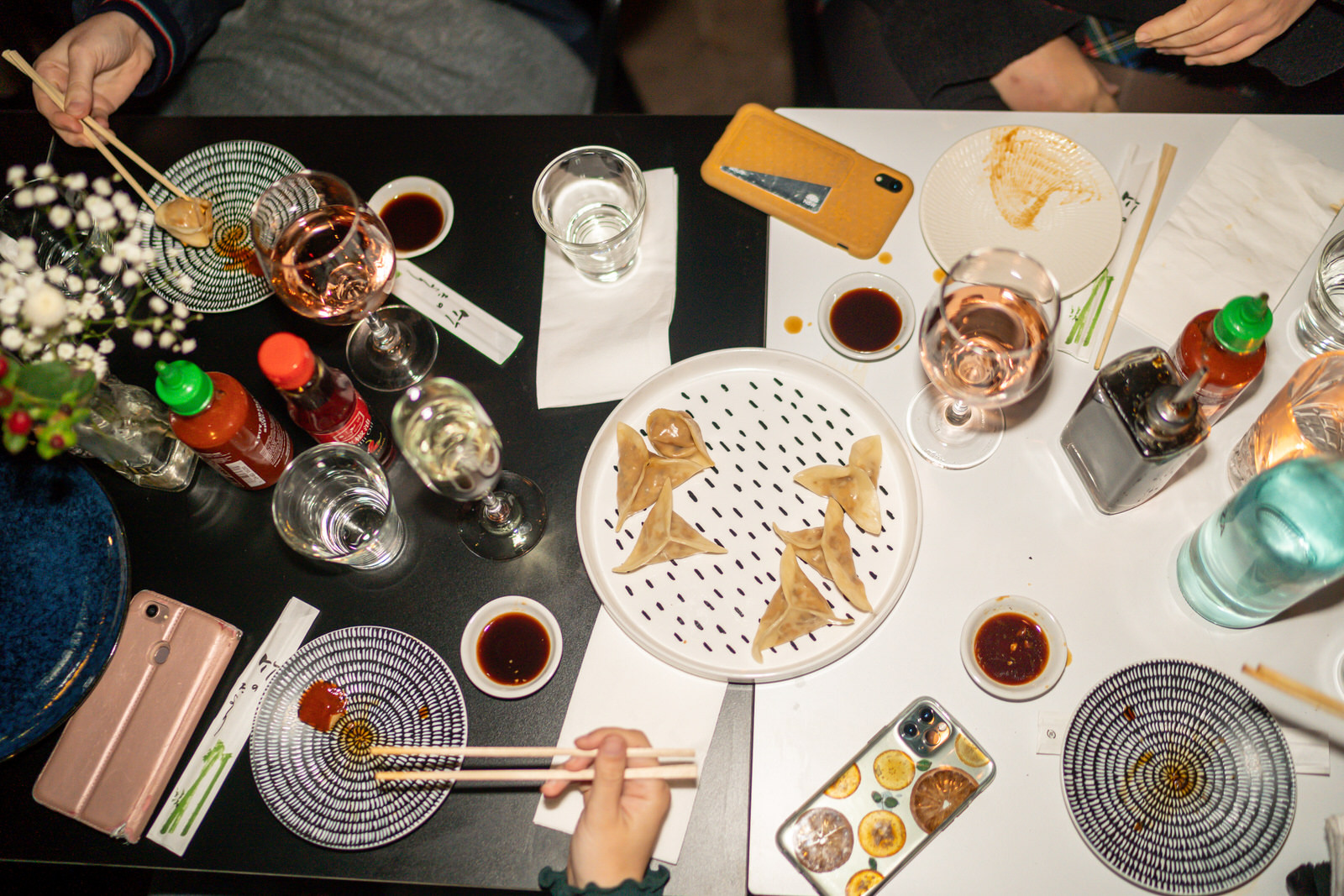 Overhead shot of a table covered with drinks and Asian food