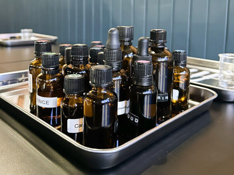 Scent bottles and essential oils on a table for a perfume making class.