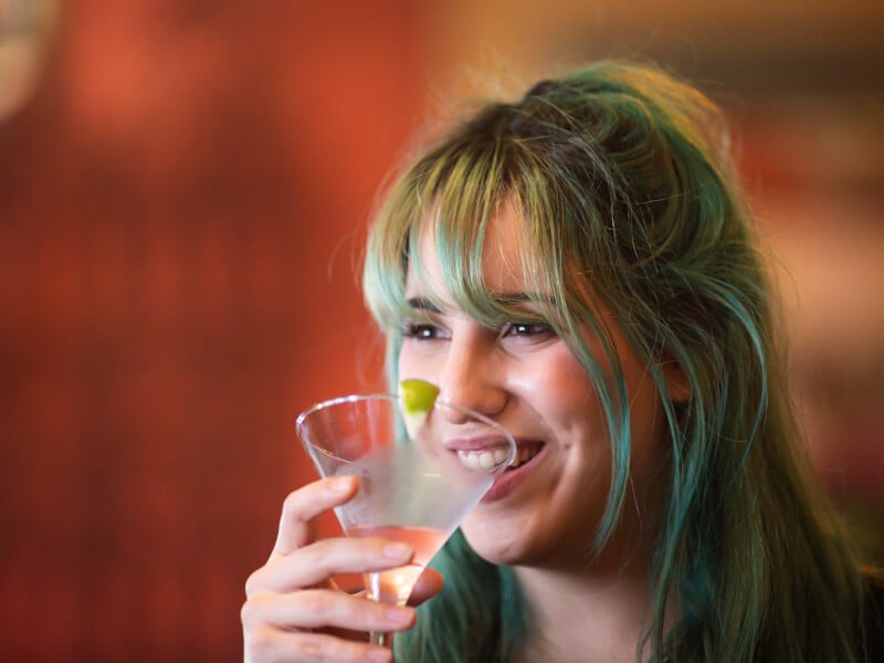 Person sipping a cocktail at a cocktail class