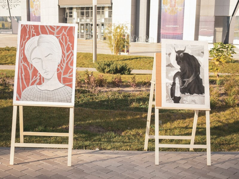 Two paintings on easels outside