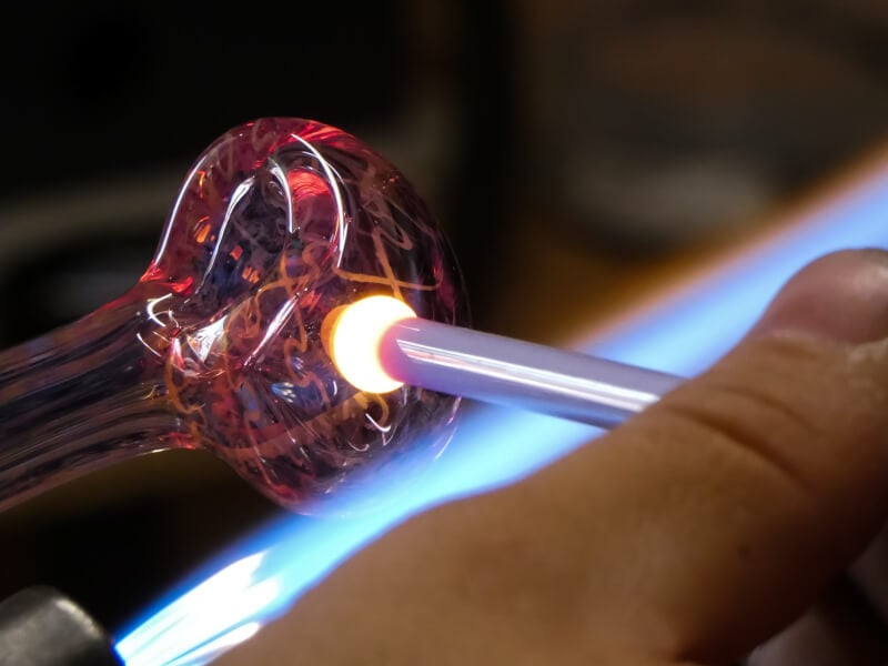 A close of image of molten glass being blown