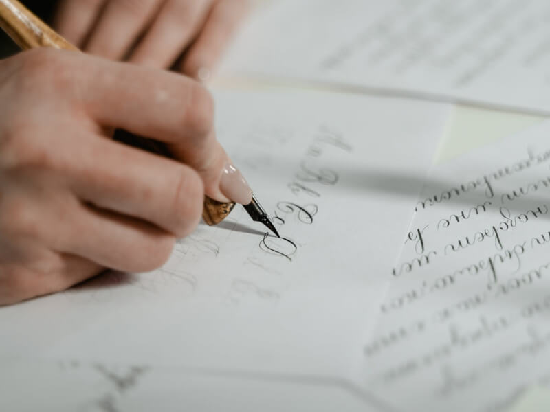 A woman writing in calligraphy