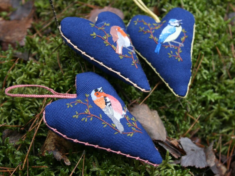 Birds embroidered on a heart shaped hanging decorations