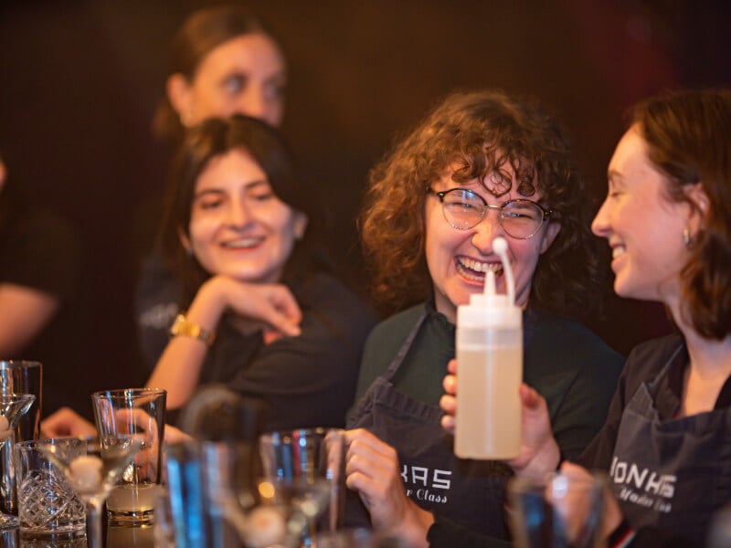 People laughing at a team building cocktail making class in London