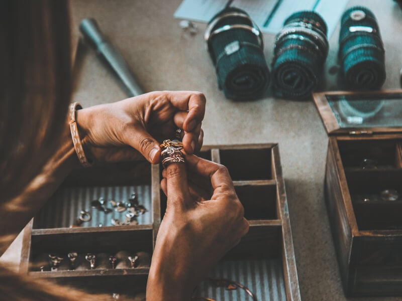 Person holding handmade rings at a jewellery making class