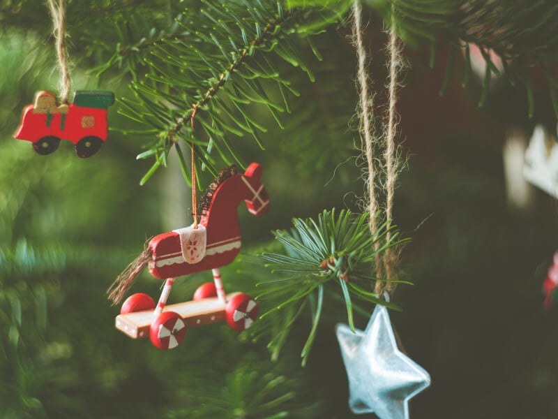 Wooden DIY Christmas decorations handing on a tree