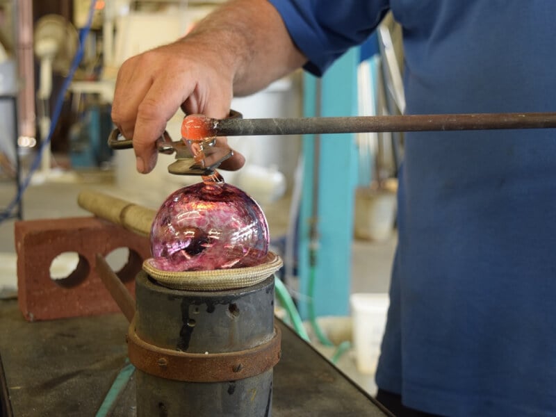 A man shaping glass