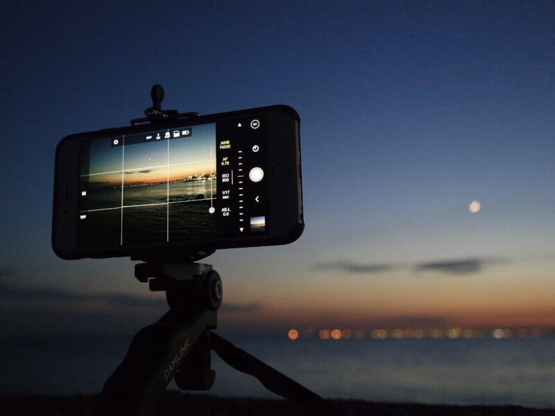 An iPhone on a tripod facing a sunset. 