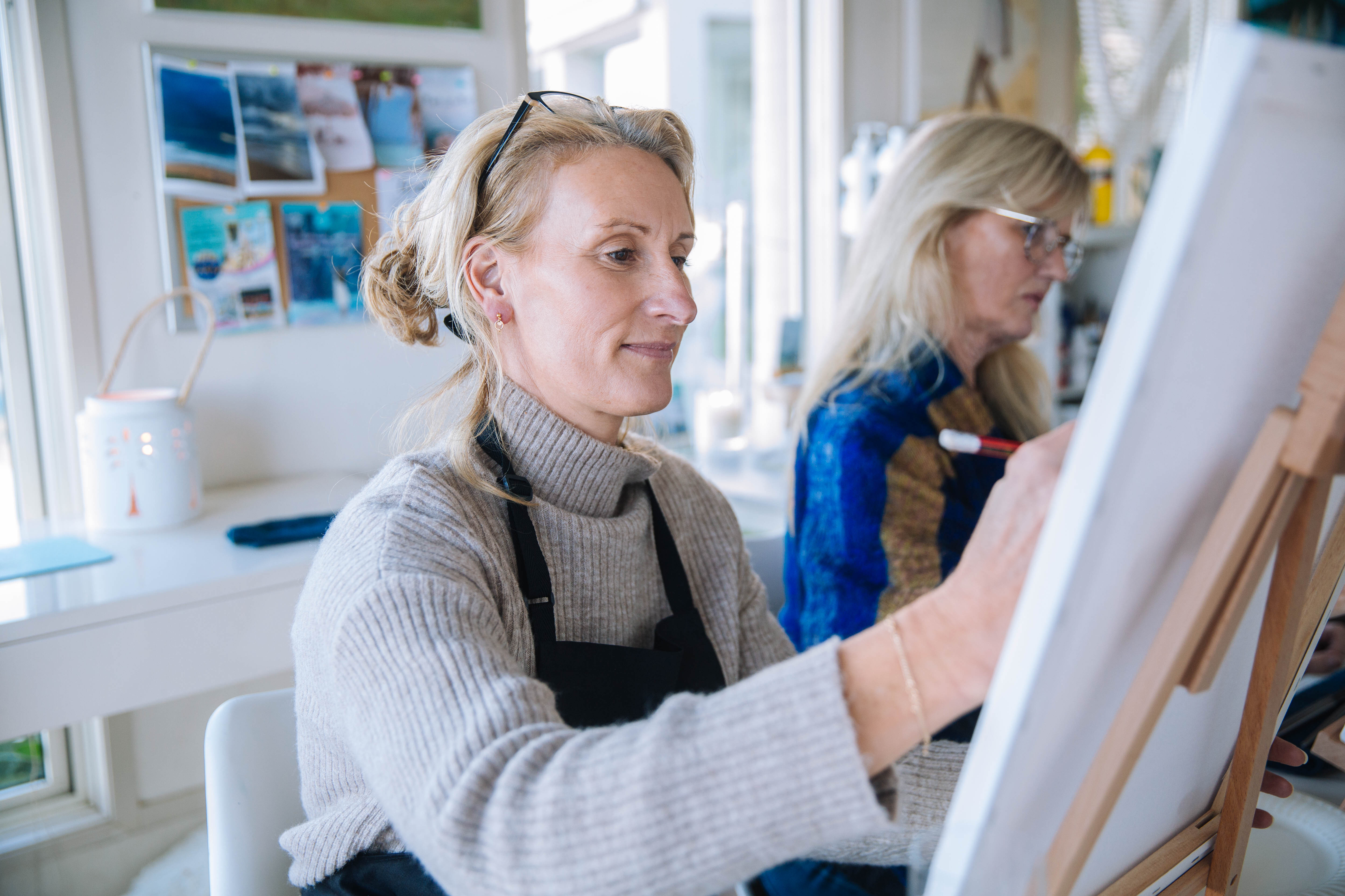 Woman sitting at an easel painting