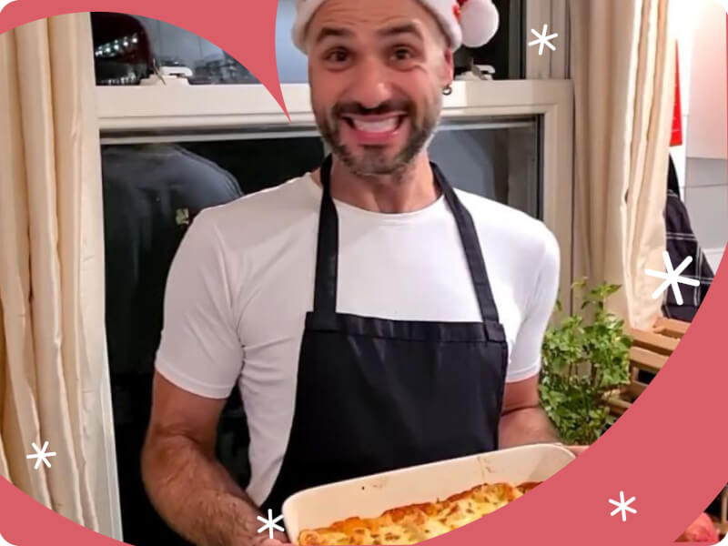 A man holding baked lasagna. 