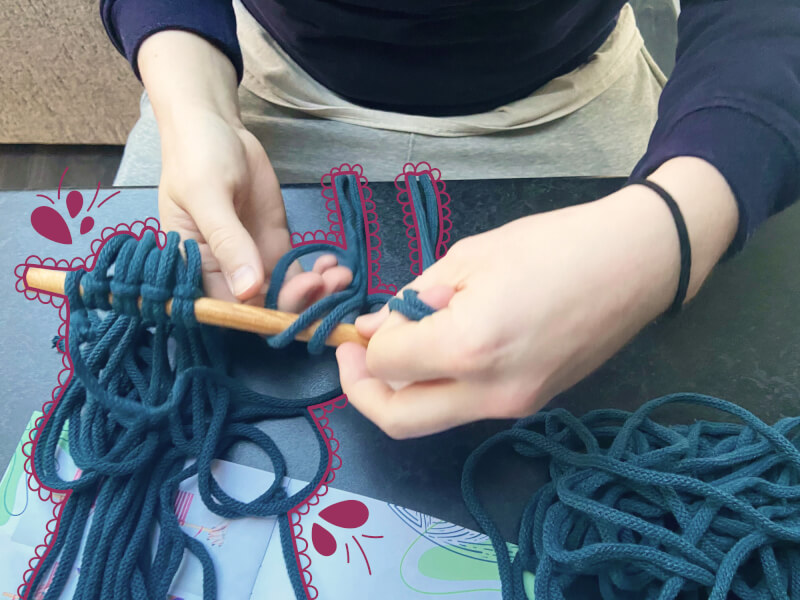 A close up view of some blue cord macrame work in progress