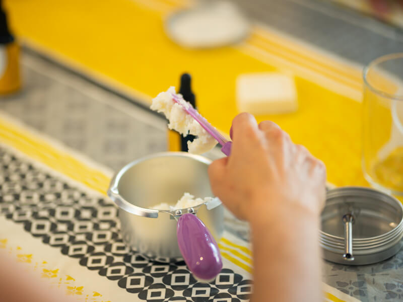 A closeup of someone making natural soap.