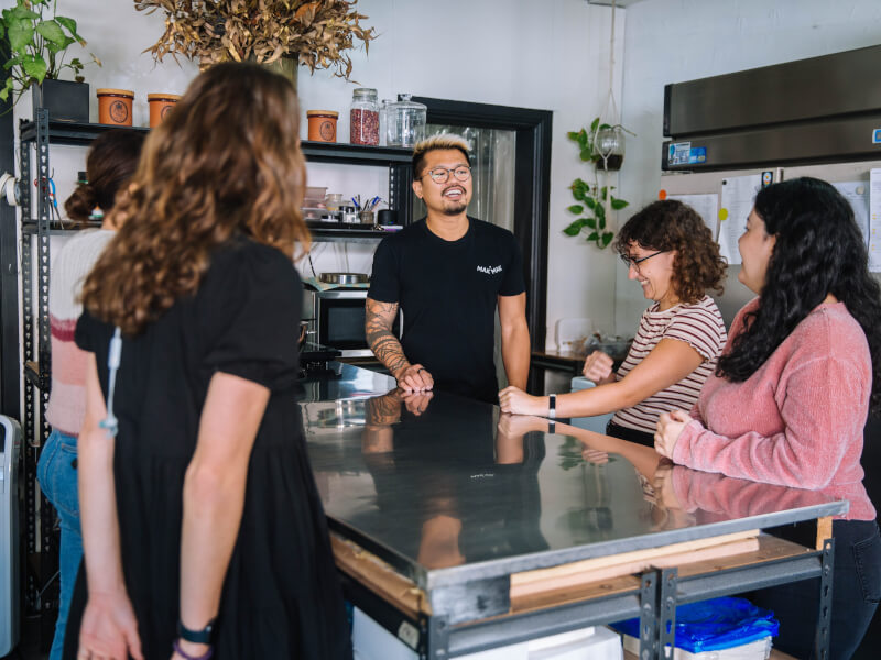 A group of people talking at a baking class in Edinburgh.