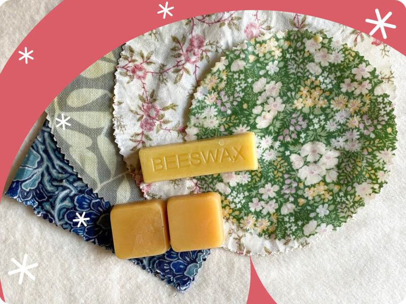 close up of beeswax melts against a floral backdrop