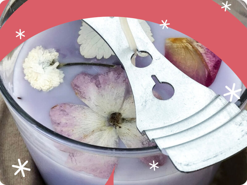 close up of a handmade candle with dried flower petals