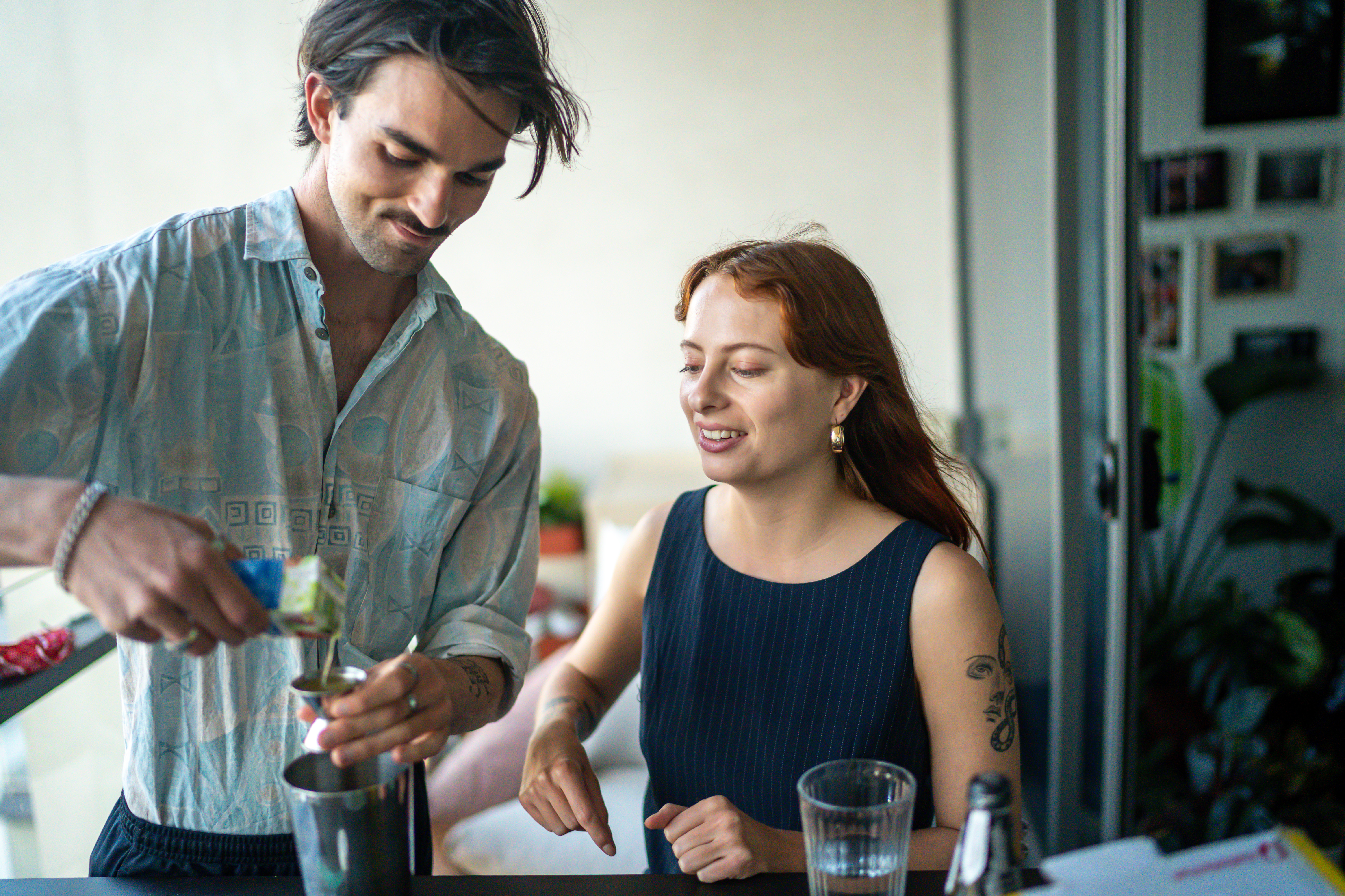 A man and woman enjoying a cocktail making class together