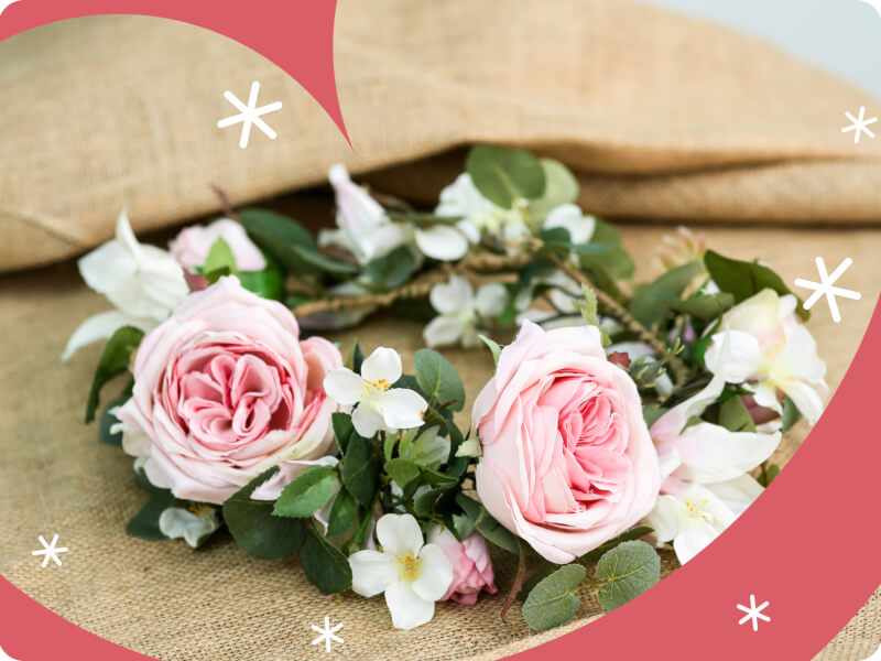 A pink DIY flower crown on hessian.