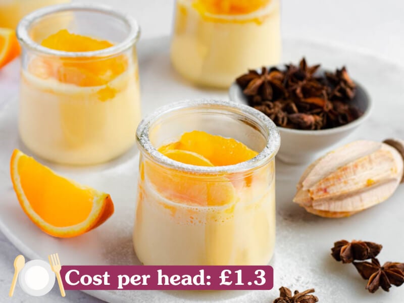 Orange desserts in small sugar-dusted pots.