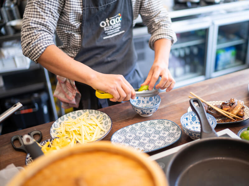 A man squeezing a lime in a cooking class in Manchester
