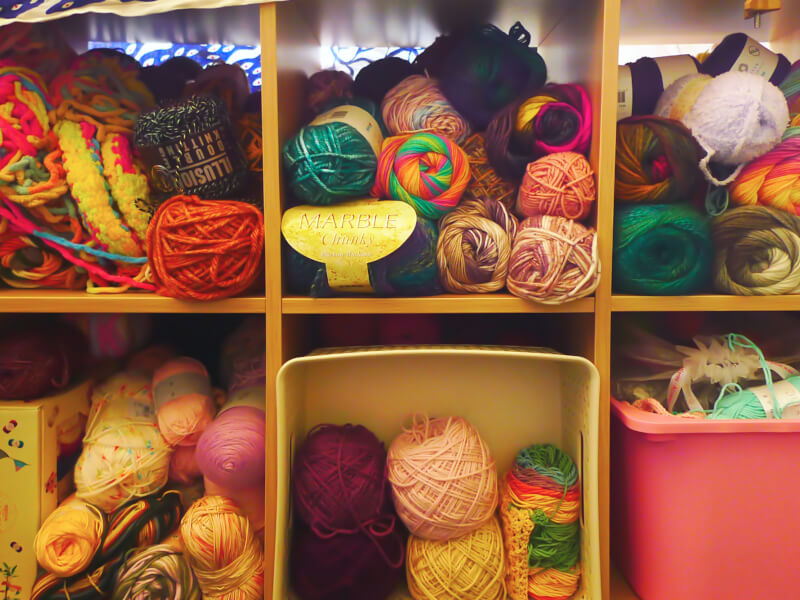 Shelves filled with crochet and knitting materials