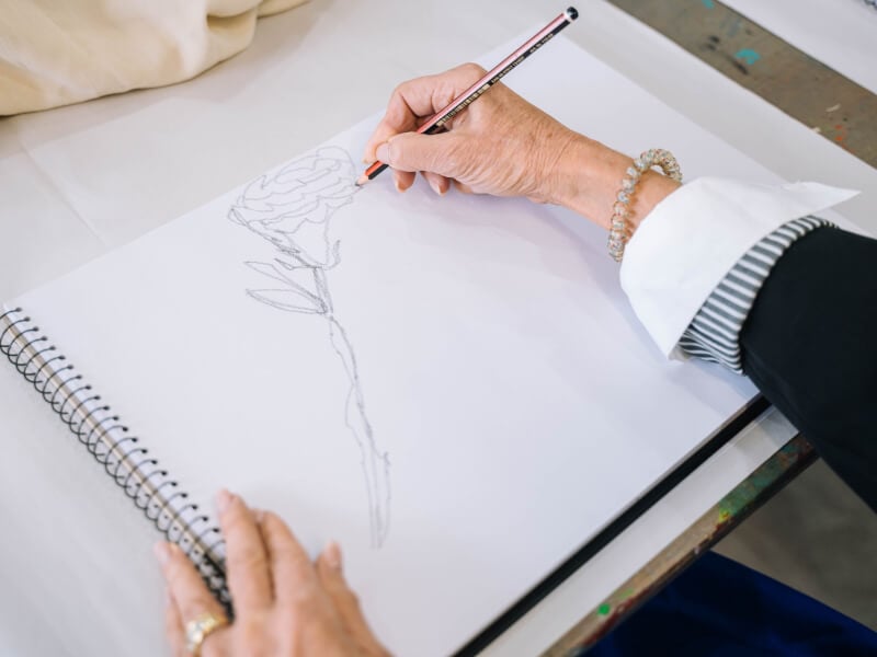 Person drawing on a sheet of paper