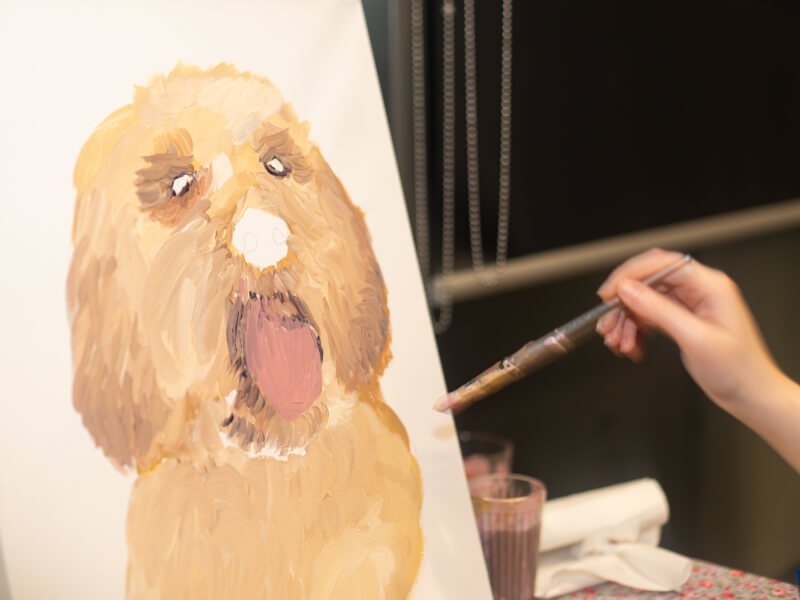 A dog being painted on canvas in an online painting class.
