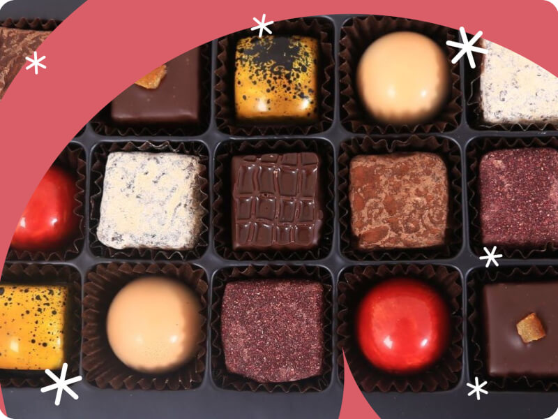 an assortment of chocolate truffles in a tray
