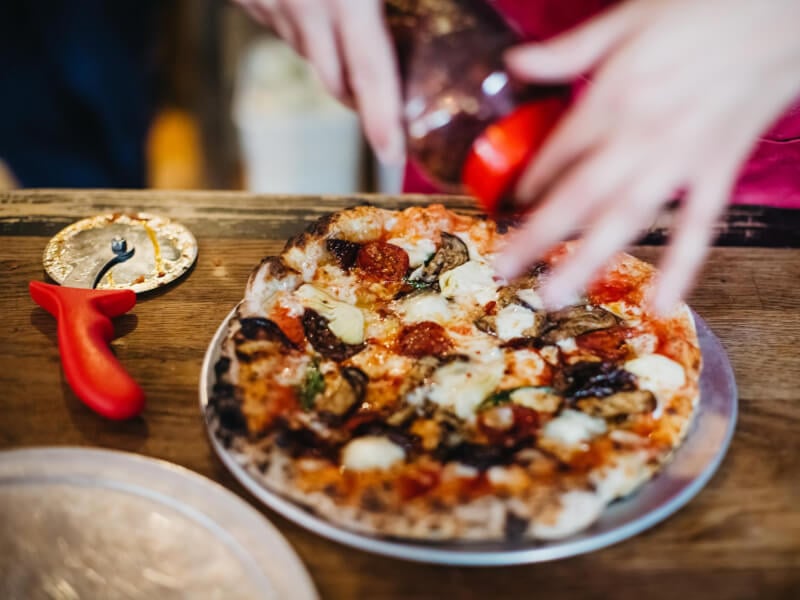 slicing a handmade italian pizza