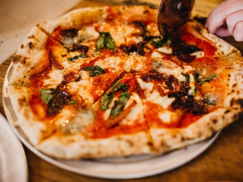 Close up of slicing a homemade pizza