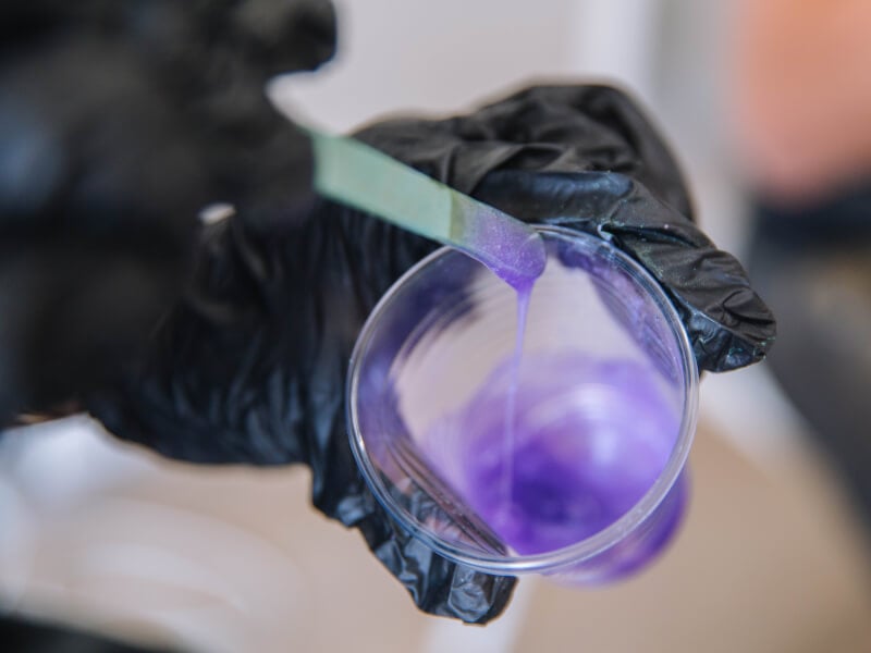 Mixing colourful resin in a plastic cup