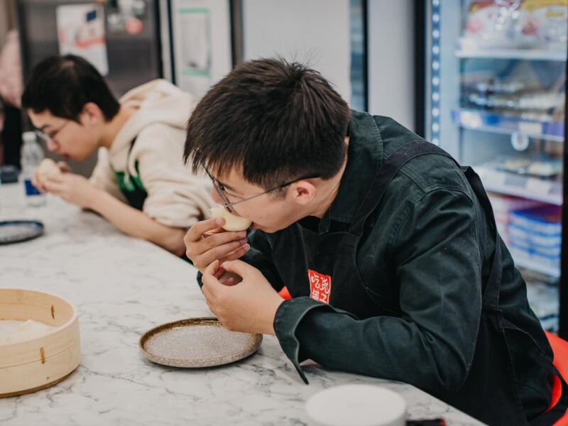 Men sampling food at a chinese cooking class