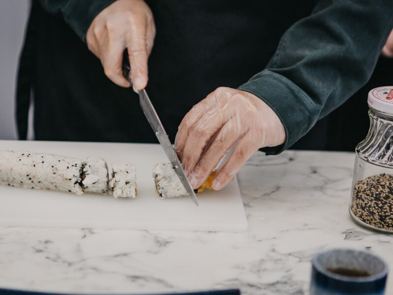 Slicing sushi at a cooking class.