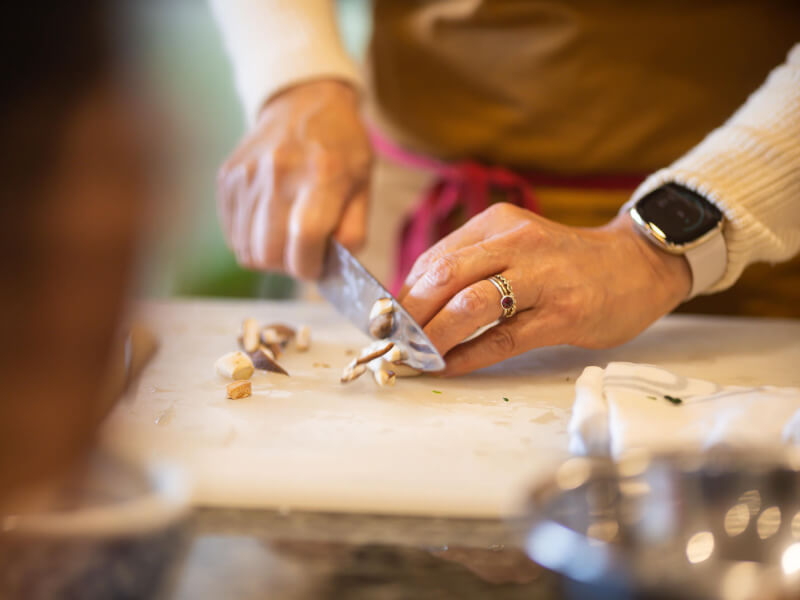Close up of a cooking teacher demonstrating knife skills