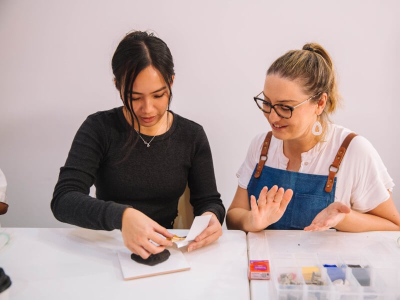Two people at a jewellery making class