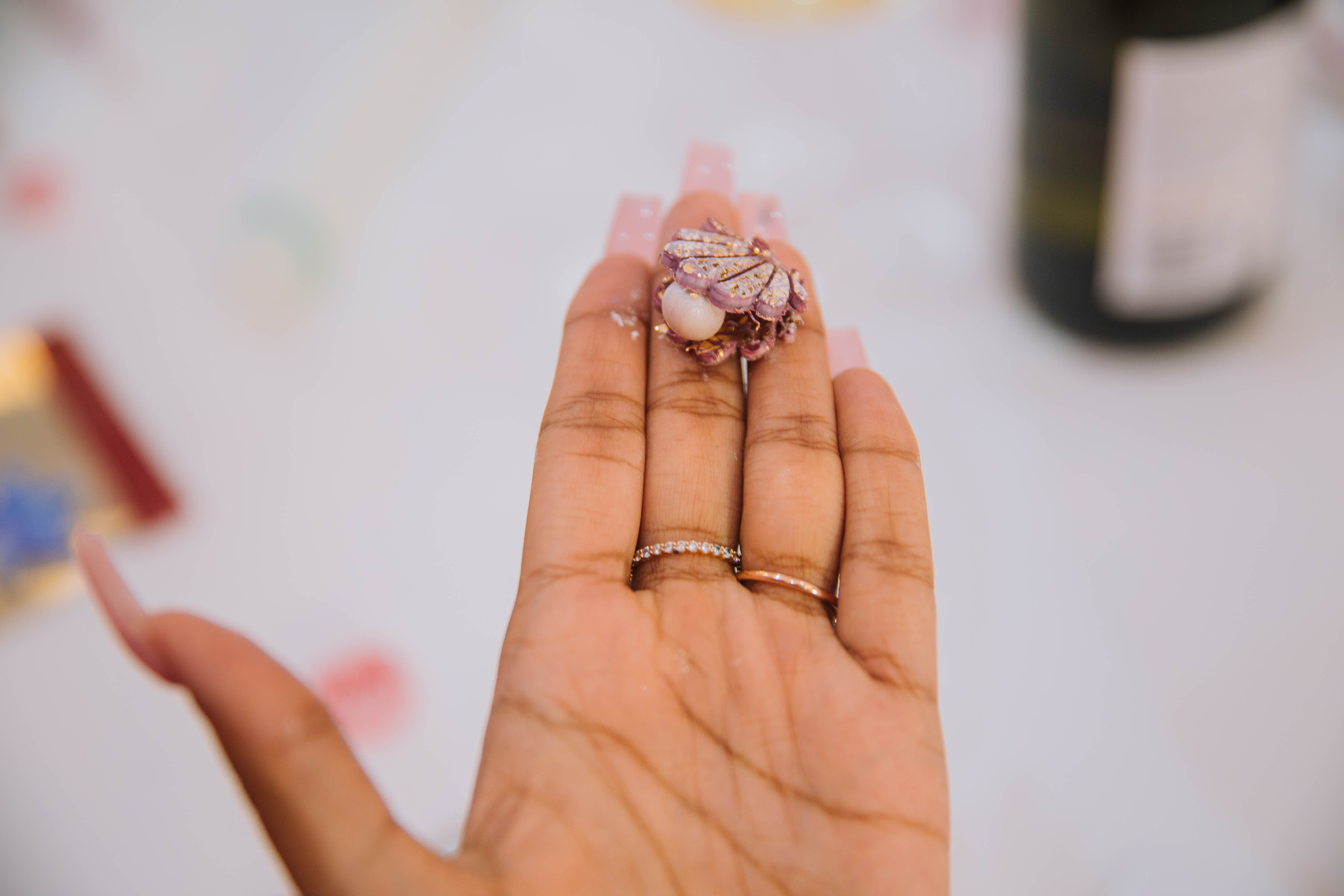 Close up of a hand holding a small piece of jewellery