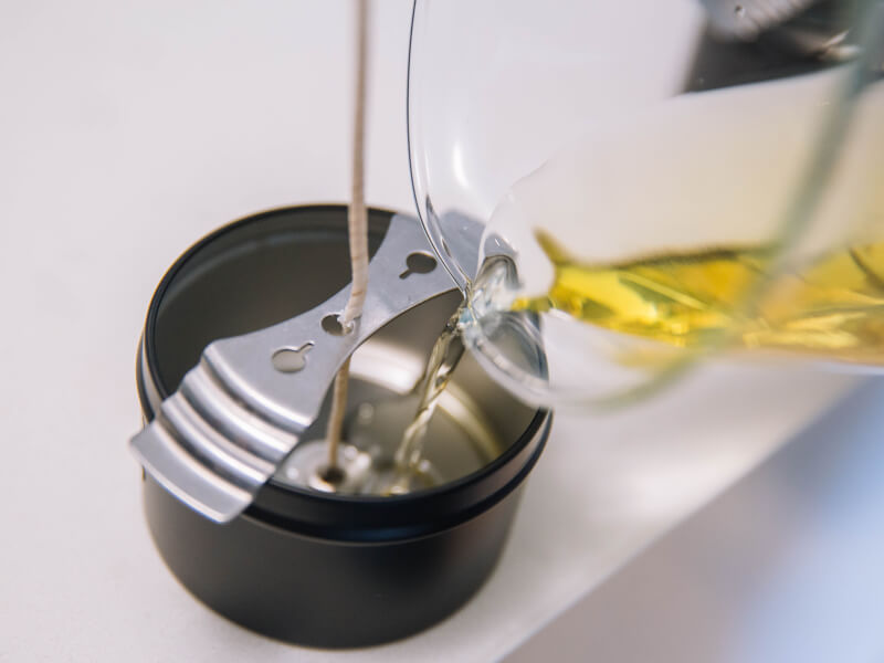 Close up of a candle in a tin as it's setting