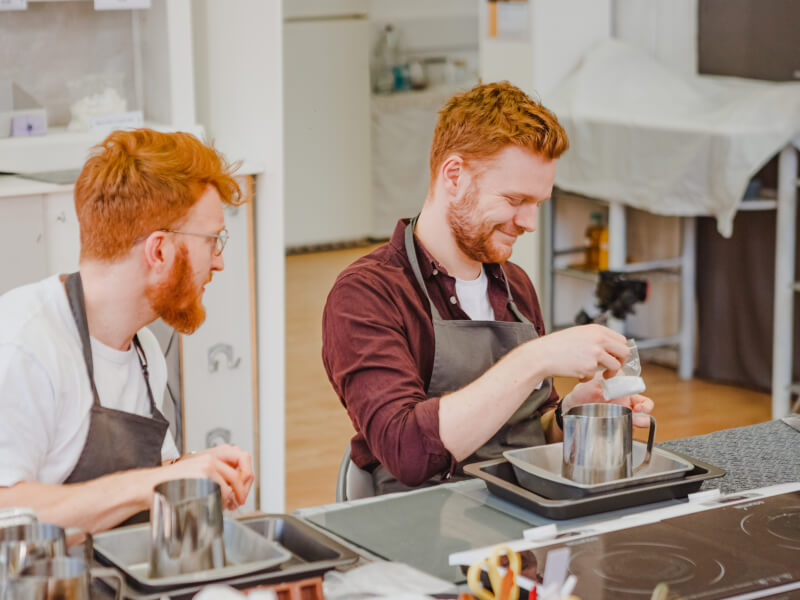 Two men making handmade candles
