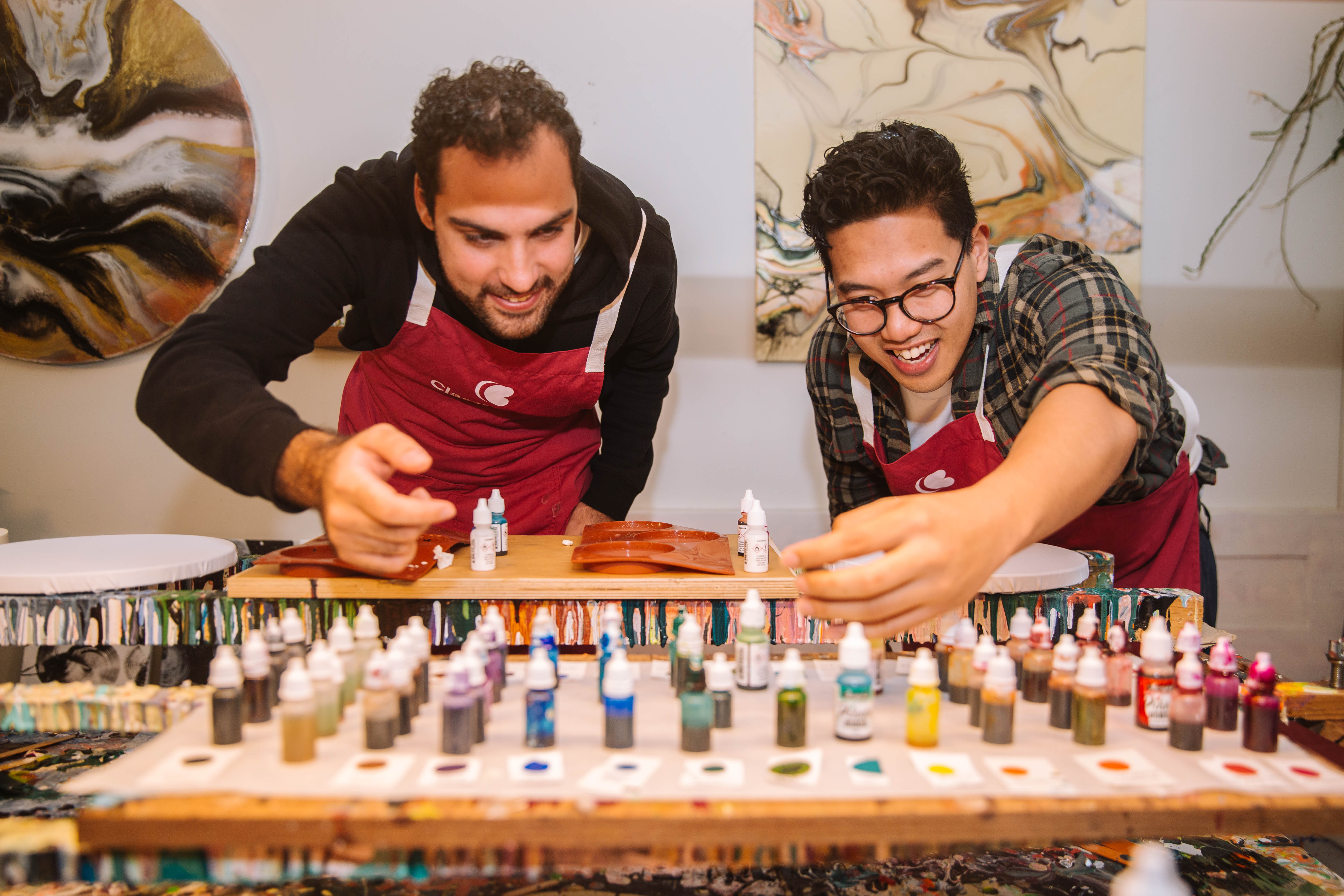 Two men choosing colours for acrylic paint pouring