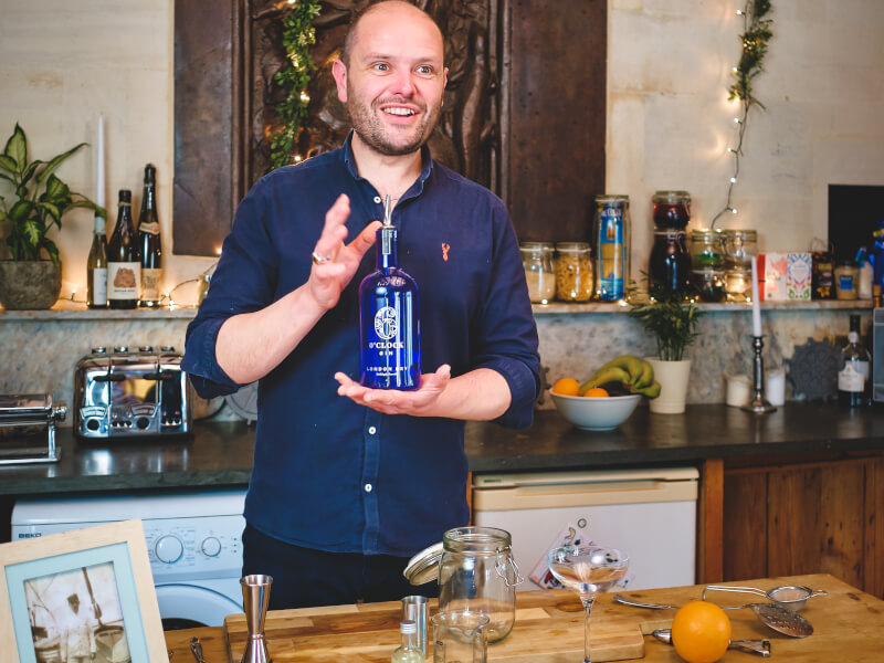 A friendly teacher helping students make delicious drinks through a virtual class.