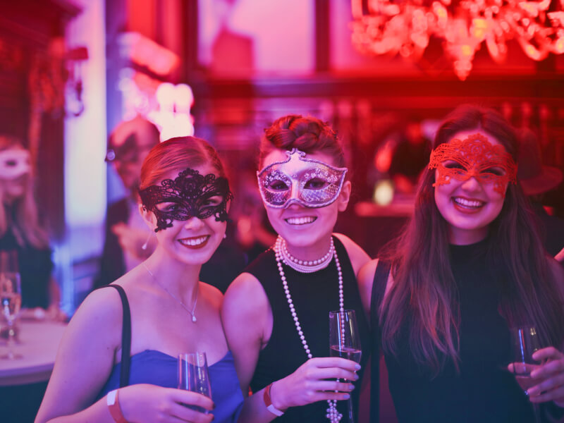 A group of people dressed in fancy dress smiling at the camera