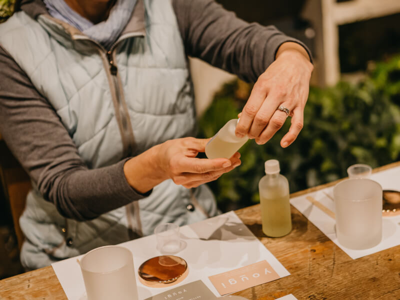 CLose up of a person mixing ingredients for a handmade candle